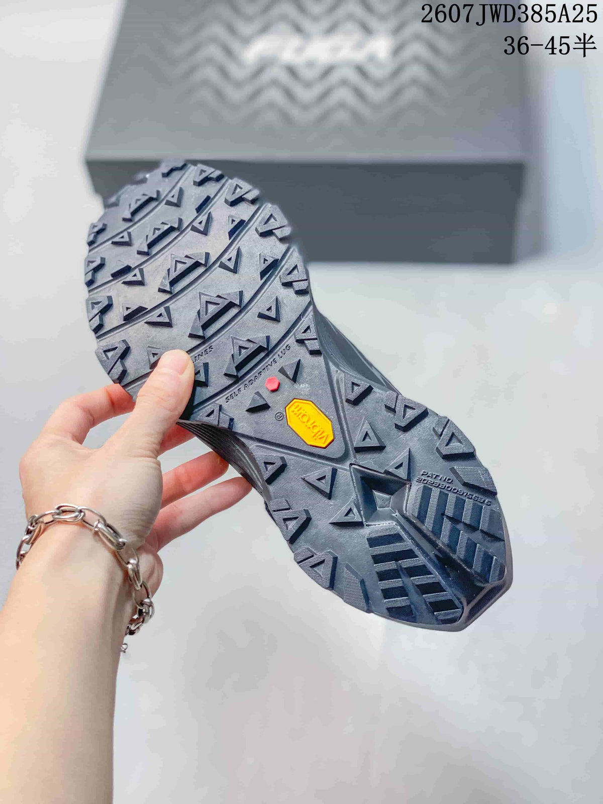 Close-up of the lugged outsole showing triangular tread patterns and Vibram branding.