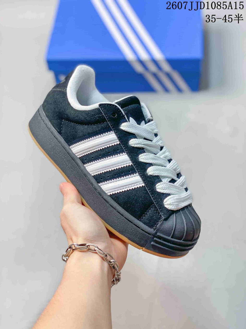 Angled side view highlighting the black upper, white stripe detailing, shell toe, and platform-style sole.