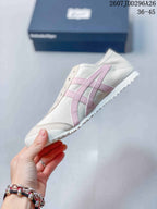 Side view highlighting the pink Onitsuka Tiger stripes and low-profile sole.