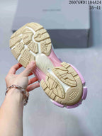 Underside view showing the textured cream and pink outsole tread of a Balenciaga Runner sneaker.