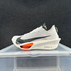 Side view of a white Nike Alphafly 3 running shoe with a black Swoosh, off-white sculpted midsole and orange forefoot detail.