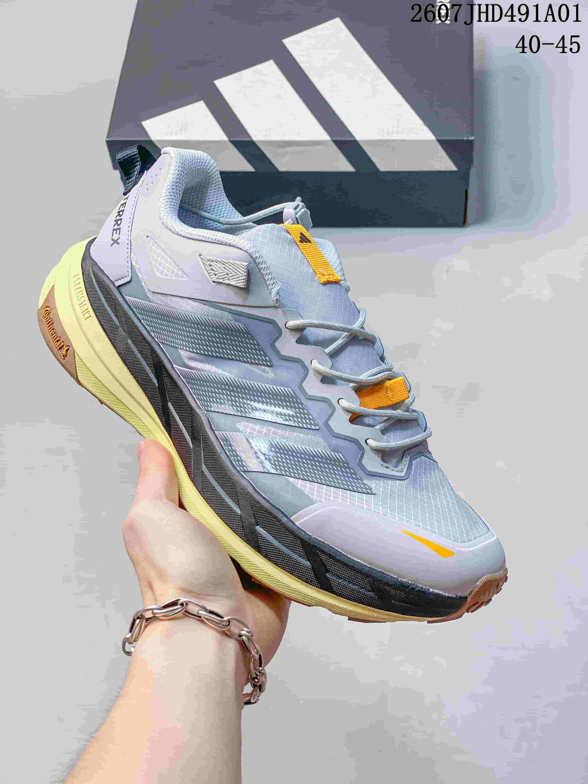 Light gray Adidas Terrex low-top shoe with yellow-orange accents; image displays the size range 40–45.