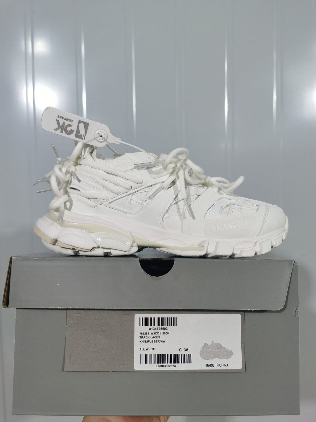 White Balenciaga lace sneaker displayed on a gray shoe box; the box label shows Track Laces and size C 38.