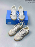 Multiple views of the two visible sneaker colorways, including dark blue-striped and burgundy-striped white pairs with blue adidas boxes.