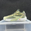 Side view of green, pale yellow and orange Jordan basketball sneakers with patterned laces and a speckled white midsole.