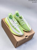 Pair of light green and white Adidas Yeezy Boost 350 sneakers displayed on a cardboard shoe box.