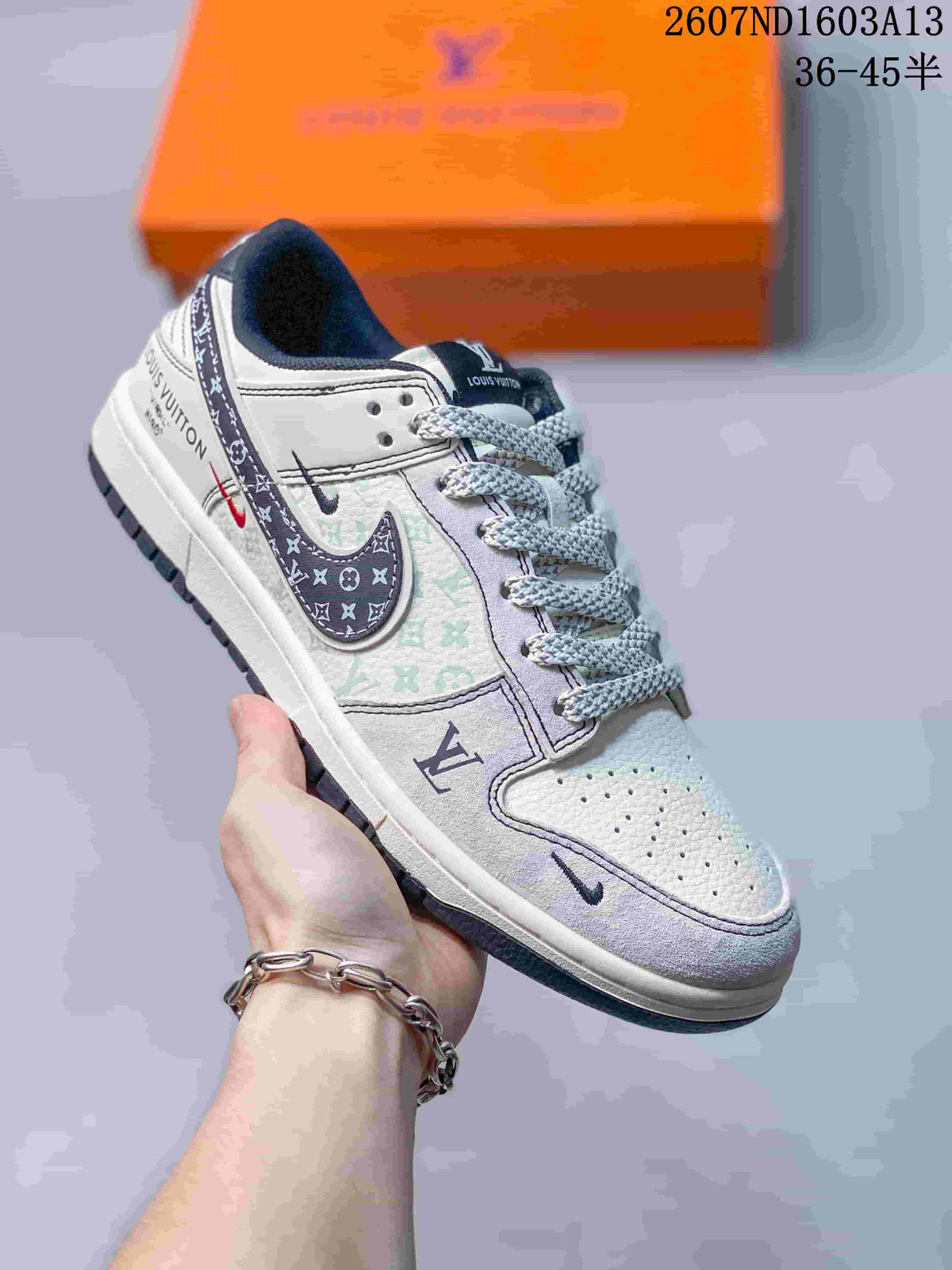 Angled side view showing the beige and gray upper, patterned Swoosh, printed panels, and outsole.