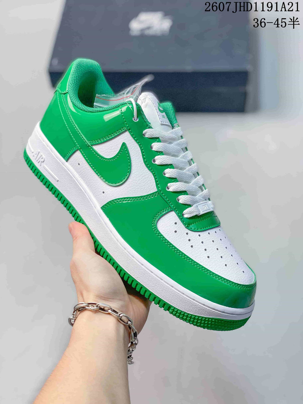 Angled side view of the green-and-white low-top sneaker showing the Swoosh, heel panel, and layered sole.