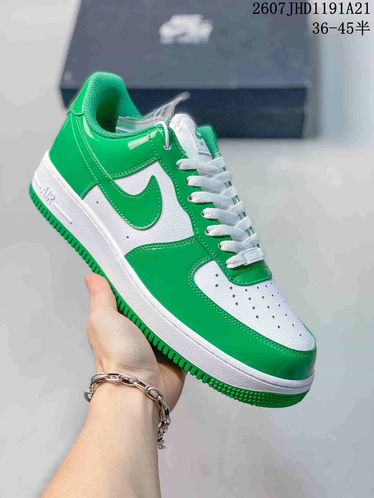 Angled side view of the green-and-white low-top sneaker showing the Swoosh, heel panel, and layered sole.