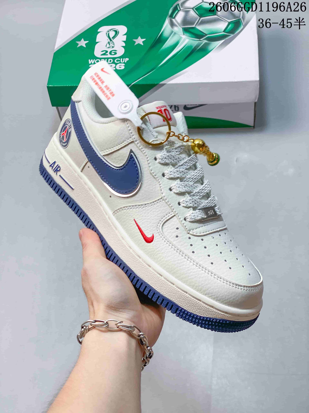 Close-up of a white low-top sneaker with a blue side Swoosh, red accent, and blue outsole.