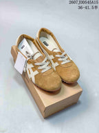 Pair of tan and cream Versace x Onitsuka Tiger sneakers displayed on a branded shoe box, with style code and size range text visible above.