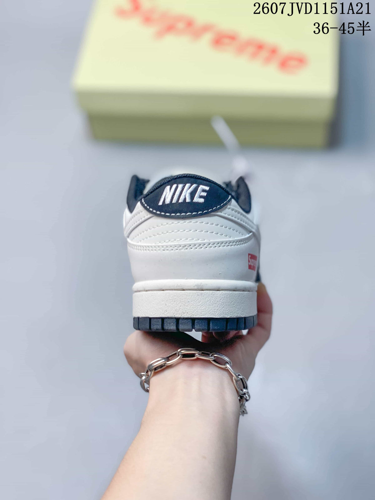 Rear view showing the white heel, dark collar, Nike branding and red accent label.