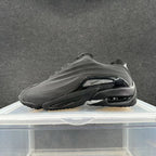 Black low-top sneaker with sculpted side panels and contrasting side accent