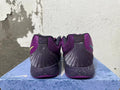 Rear view of purple Nike basketball shoes with dark stitched heel panels and speckled midsoles