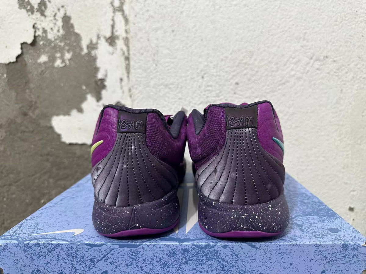 Rear view of purple Nike basketball shoes with dark stitched heel panels and speckled midsoles