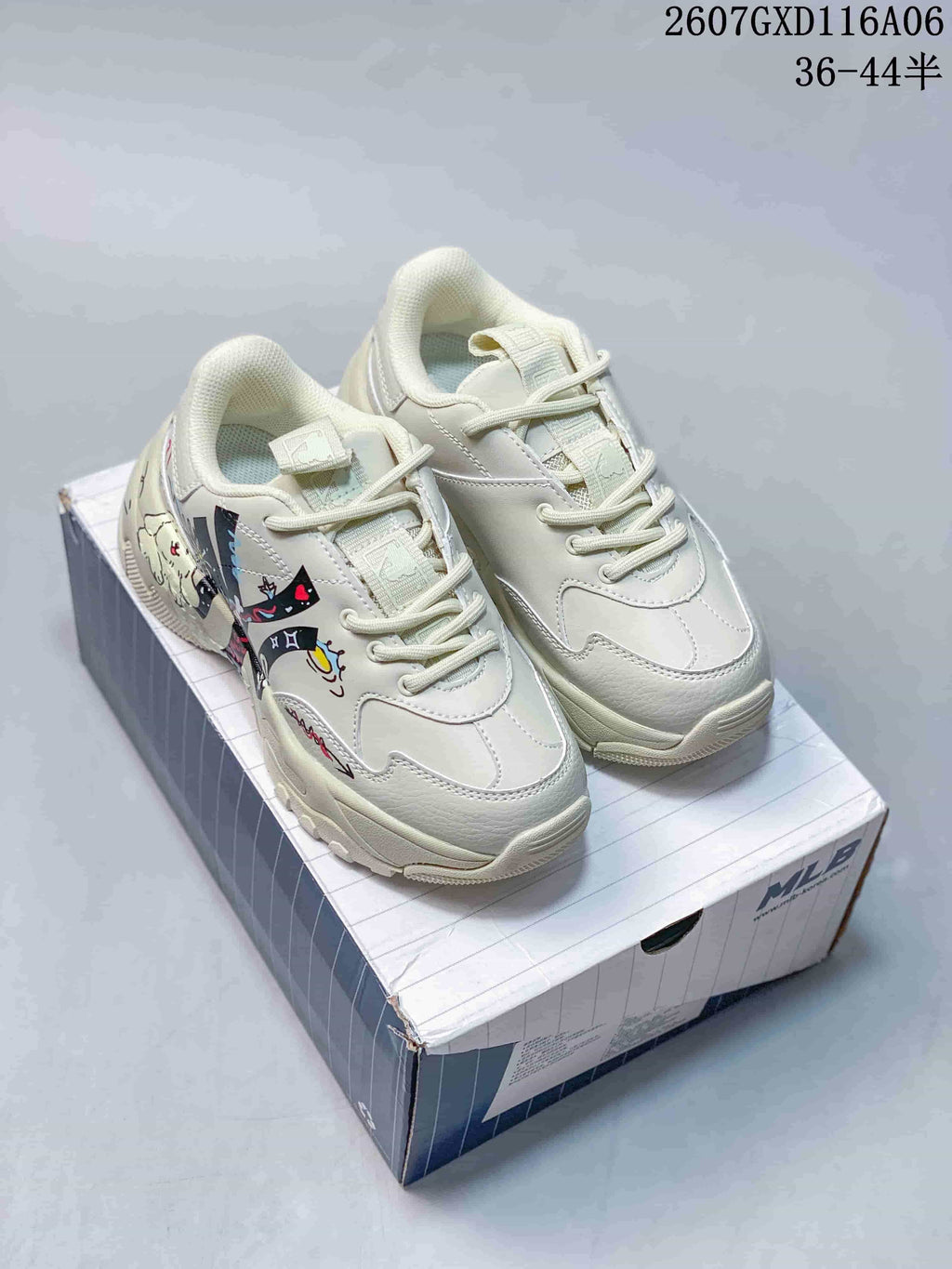 Pair of cream beige MLB Big Ball Chunky sneakers with colorful doodle artwork, shown on a branded shoe box.