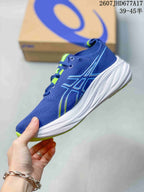 Side profile of the blue running shoe with ASICS branding, bright green accents and a white midsole.