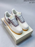 Pair of ivory and mauve low-top sneakers with patterned side panels and gum-yellow outsoles, shown on a box.