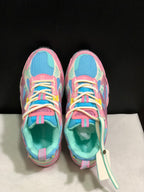 Top view showing the round toes, cream laces, pink overlays and blue mesh panels.