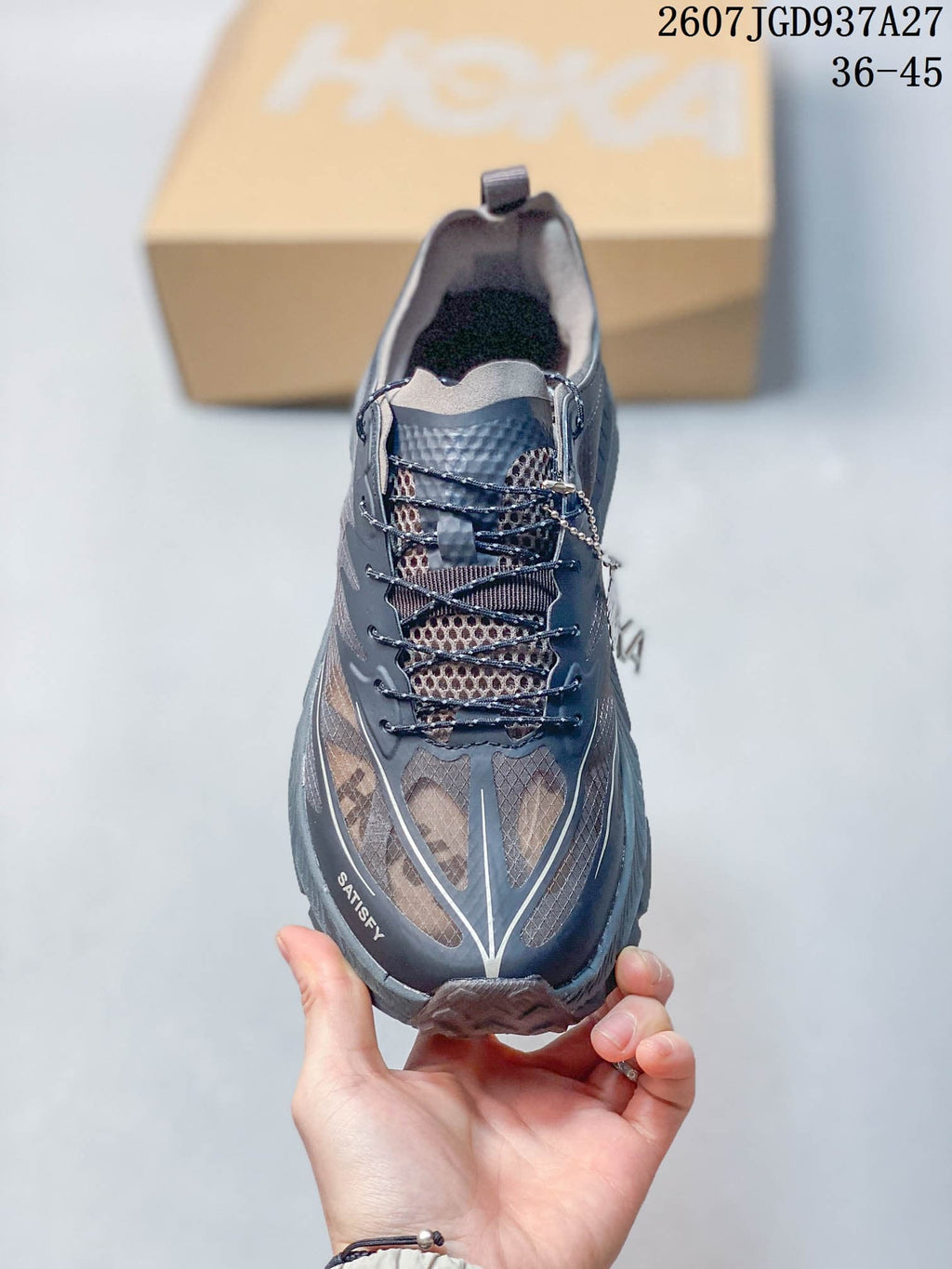 Top view showing the black and gray lace-up design, layered toe panels, and SATISFY branding near the toe.