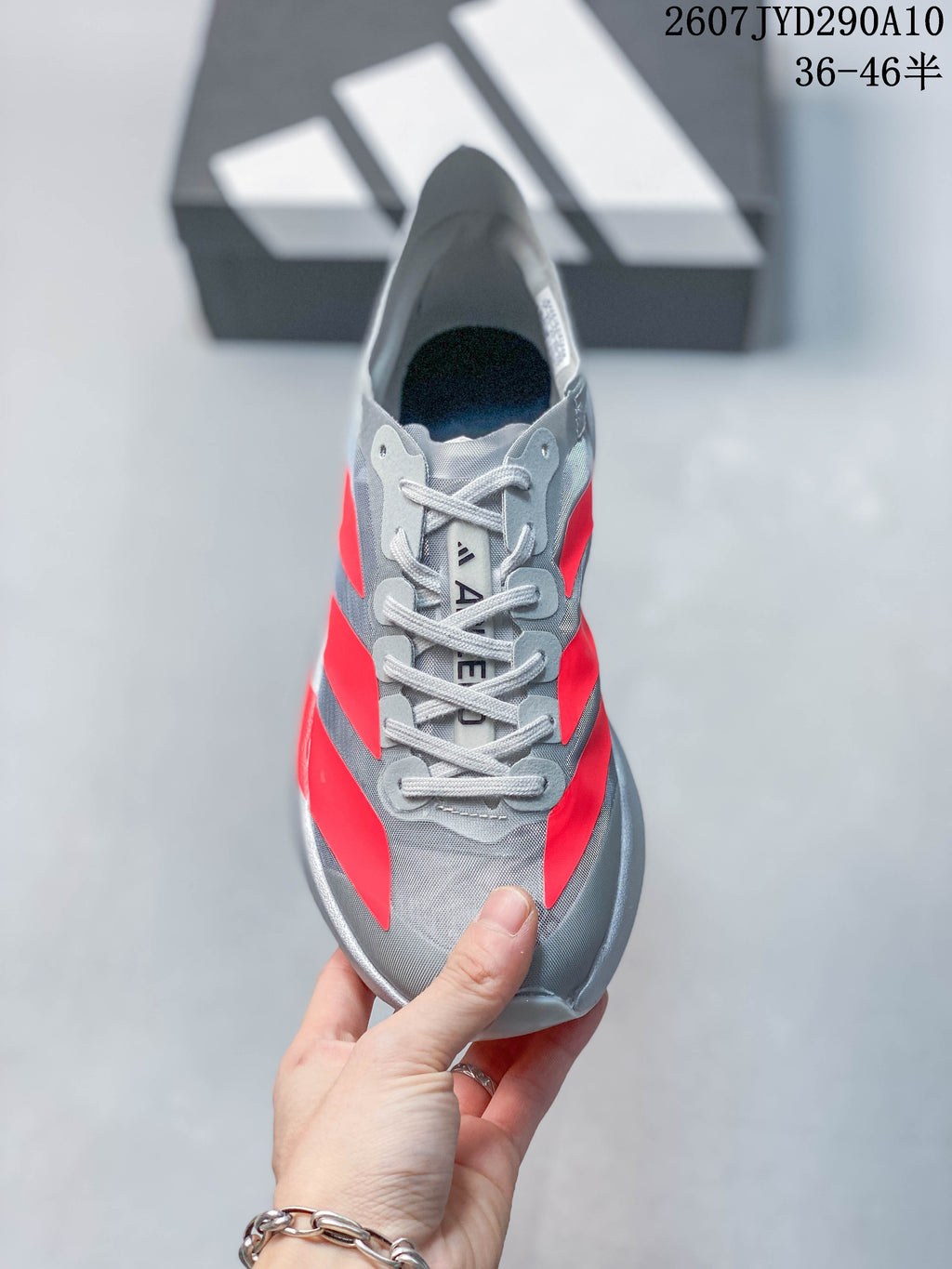 Top view showing the gray lace-up design, tongue branding, and red side accents.