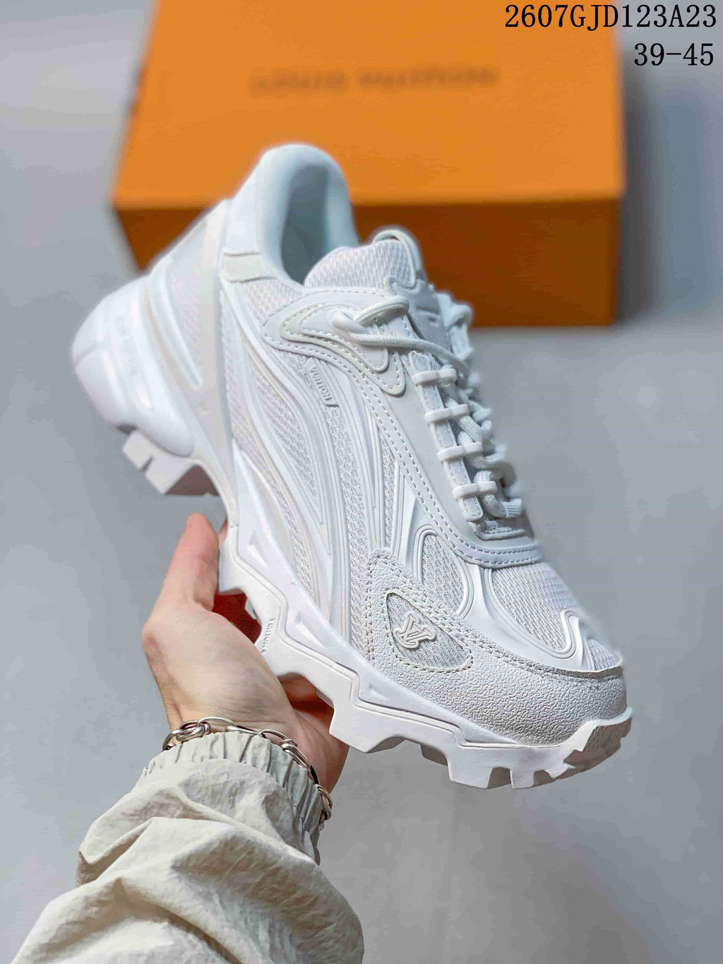 Close-up side view of a white Louis Vuitton Summit sneaker with layered upper panels, lace fastening, and a thick rugged outsole.