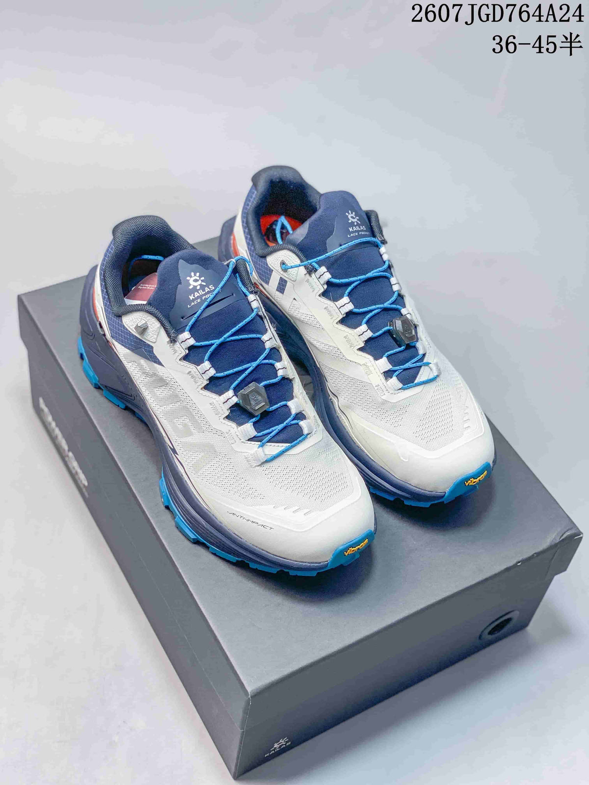 Pair of KAILAS FUGA EX3 trail running shoes in white and navy with blue laces, displayed on a shoebox.