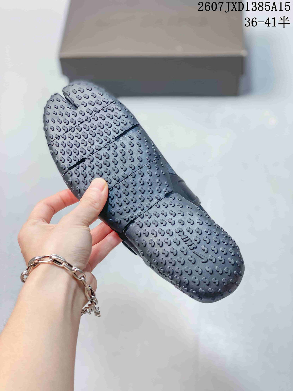 Underside view of a black Nike Air Rift shoe showing the textured, patterned outsole.