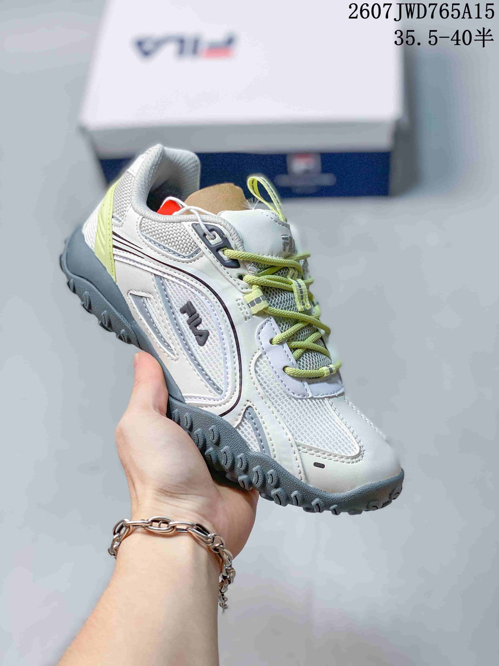 Angled side view of the white FILA Pebble sneaker with lime accents