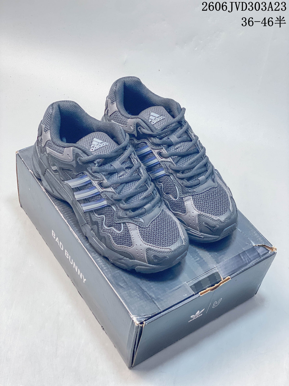 Pair of grey adidas Response CL Bad Bunny sneakers on a branded box