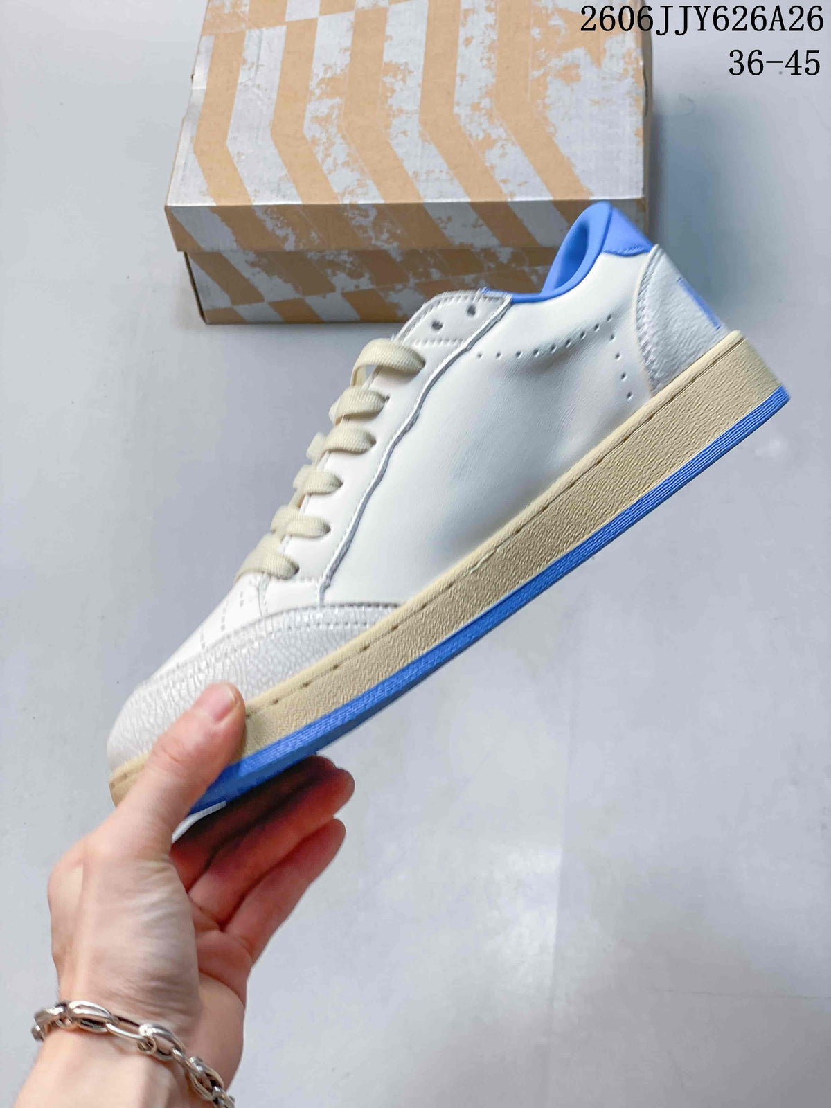 Side profile showing the white perforated upper, blue outsole edge, and beige-toned midsole.