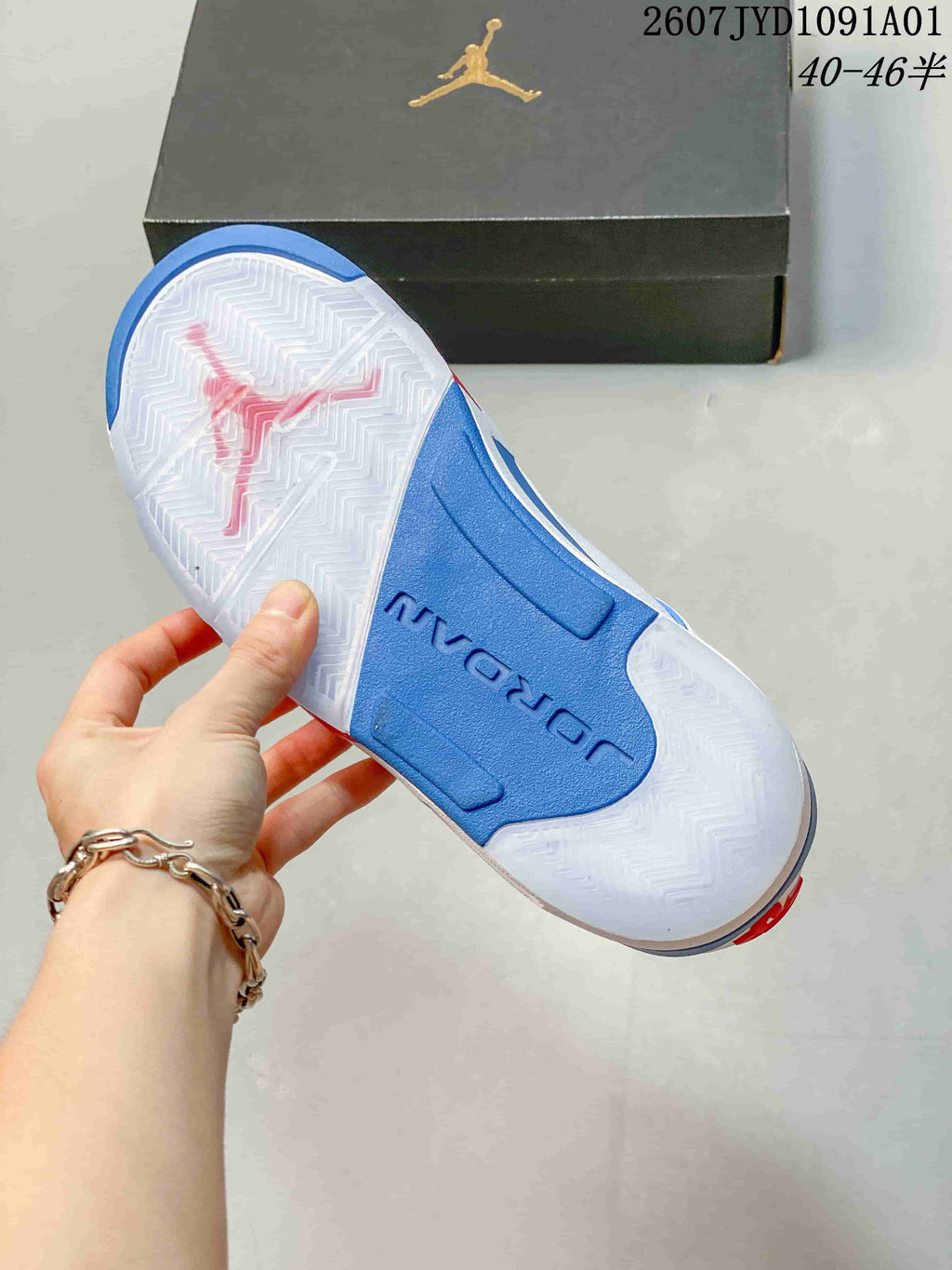 Outsole view showing a white patterned tread and blue midfoot section