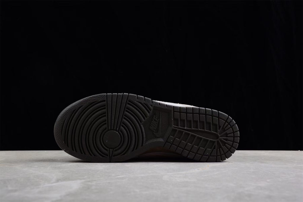 Underside view showing the black rubber outsole with circular traction grooves and segmented tread.