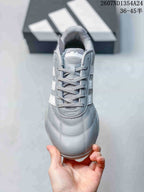 Top view showing the rounded toe, gray laces, tongue, and stitched panel details.