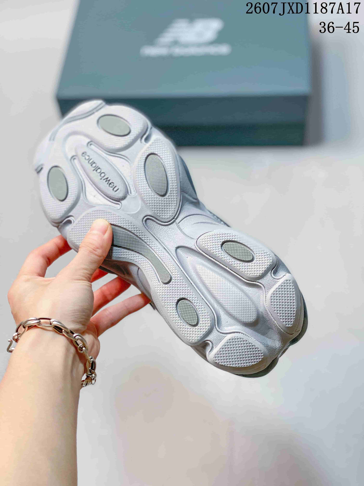Close-up of the grey sneaker outsole showing its sculpted tread and segmented cushioning areas.