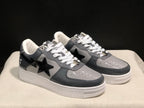 Three-quarter view of the pair with dark gray panels, black star details, and white soles.