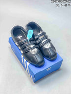 Black adidas Originals ANFU MJ sneakers with three straps, shown on a blue shoebox