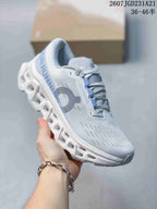 Angled side view of the white and light blue sneaker with visible On branding and open-segment outsole.