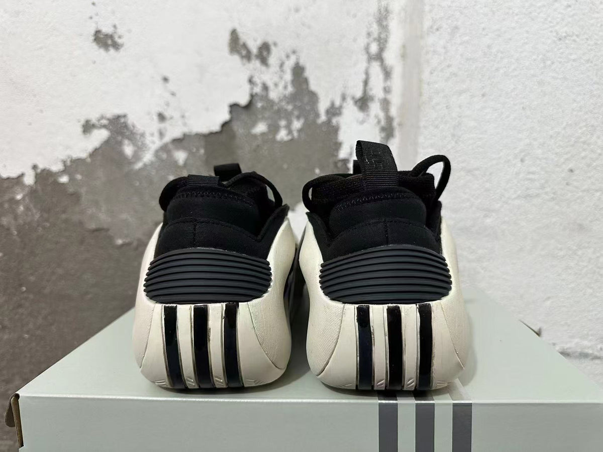 Rear view of black sneakers with white heel panels and ribbed details