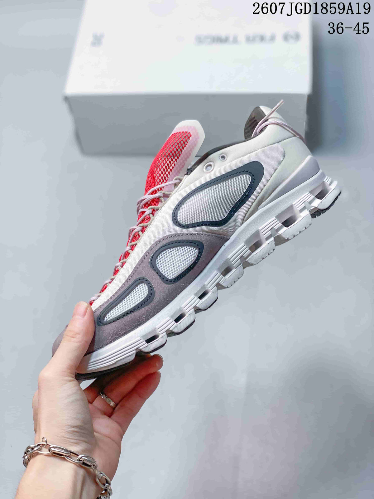 Side profile of the sneaker showing layered mesh panels, gray overlays, and a segmented sole.