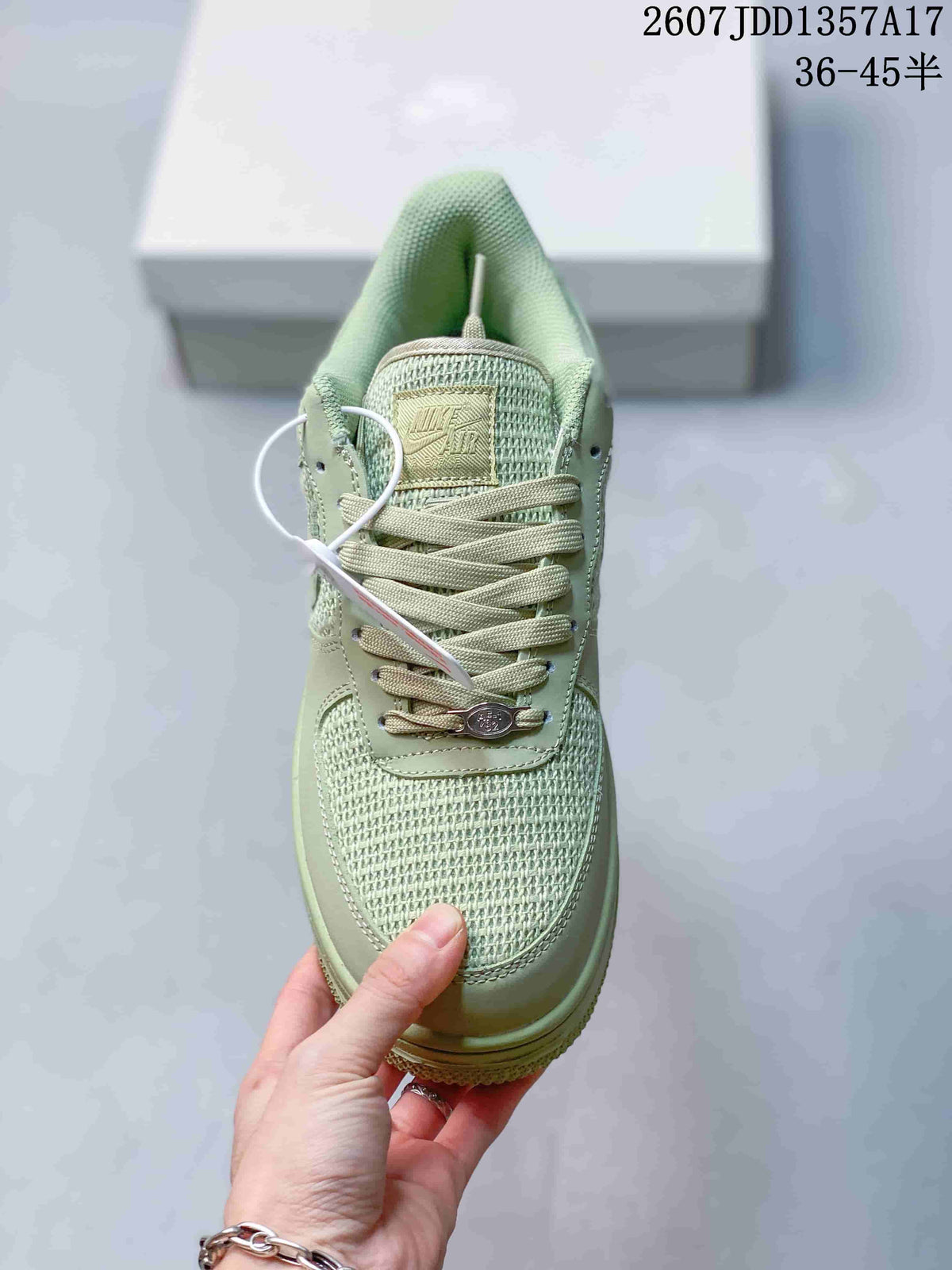 Top view of the pale green sneaker showing woven toe panels, tonal laces and a decorative lace accessory.