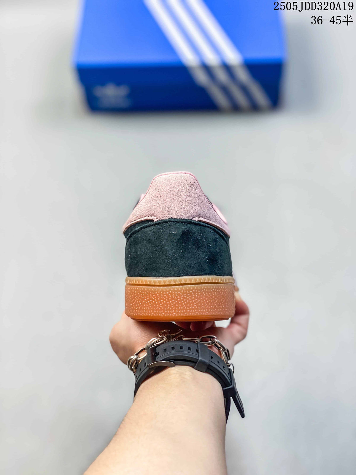 Rear view of the sneaker showing the black heel, pink collar, and gum outsole.