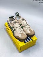 Pair of cream Onitsuka Tiger MEXICO 66 sneakers with green stripes and brown toe overlays displayed on a yellow shoe box; style code and size range are visible at the top right.