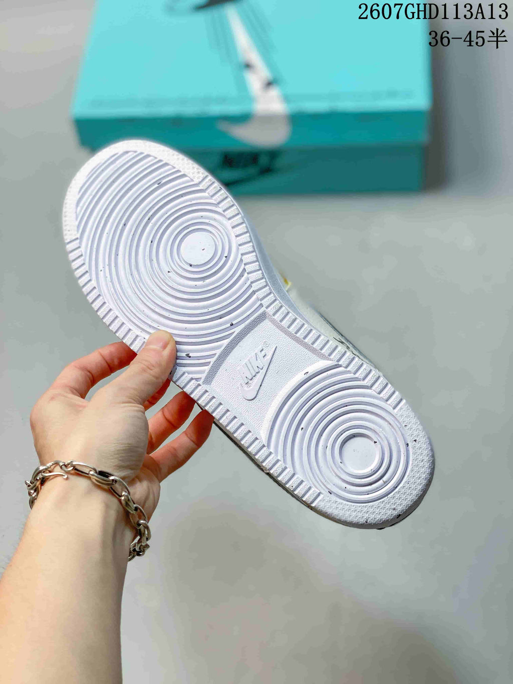 Close view of the white rubber outsole showing concentric circular tread patterns and an embossed Nike mark.