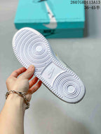 Close view of the white rubber outsole showing concentric circular tread patterns and an embossed Nike mark.