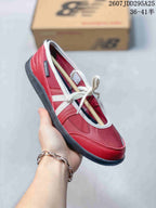 Close-up side view of a red New Balance low-top sneaker with white trim, laces, and dark outsole.
