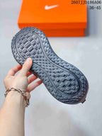 Bottom view showing the textured outsole pattern of a dark sneaker.