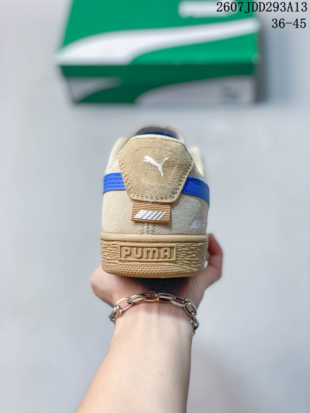Rear view of the tan sneaker showing the PUMA heel branding and blue heel stripe.