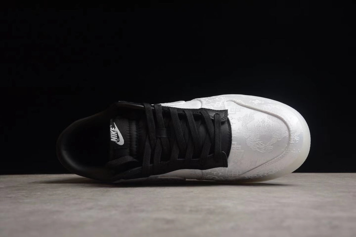 Top view showing the black lace panel, black collar, and white patterned toe box.