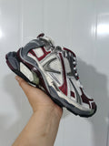 Close-up three-quarter view of Puma Runner sneakers in metallic white, gray, and wine red.